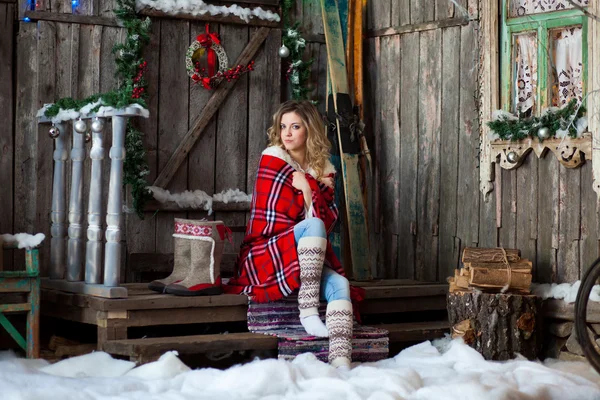 Girl about Christmas porch covered with a heated blanket