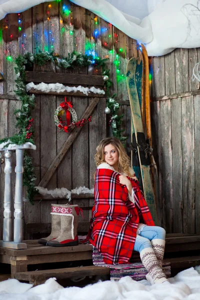 Girl about Christmas porch covered with a heated blanket