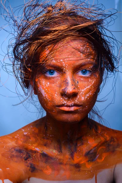 Woman with a red face, body art