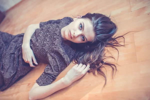 Seductive woman lying on the floor