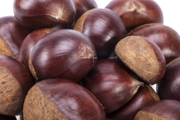 Heap of raw sweet  chestnuts , close up