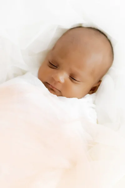 Three weeks old baby sleeping on white blanket cute infant newborn lying down close up shot eyes closed