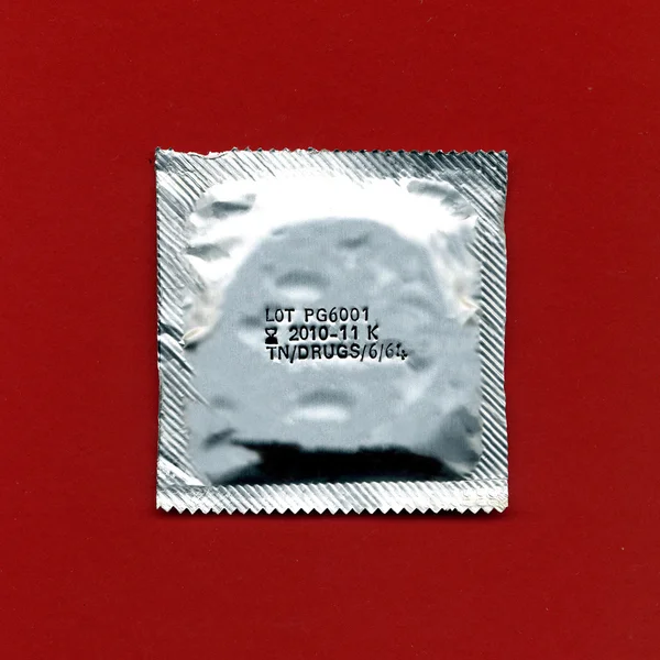 Condom pack over red background