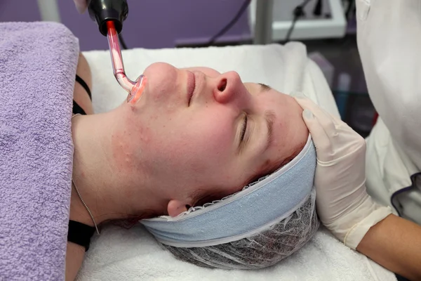 Beauty treatment of young female face