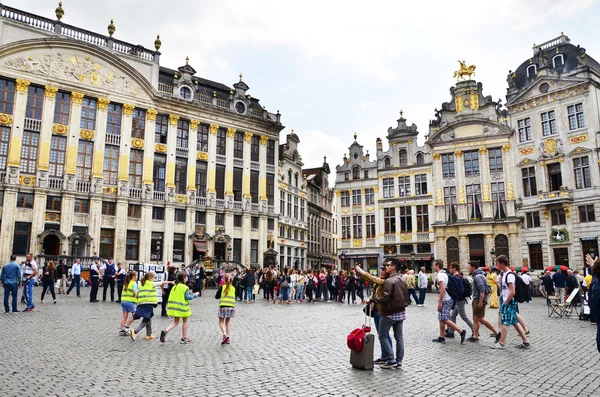 Brussels, Belgium - May 13, 2015: Many tourists visiting famous Grand Place (Grote Markt) the central square of Brussels.