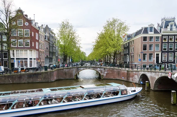 Amsterdam, Netherlands - May 7, 2015: Passenger boats on canal tour in the city of Amsterdam.