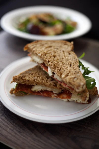 Italian salami and sheep cheese sandwich with brown bread.