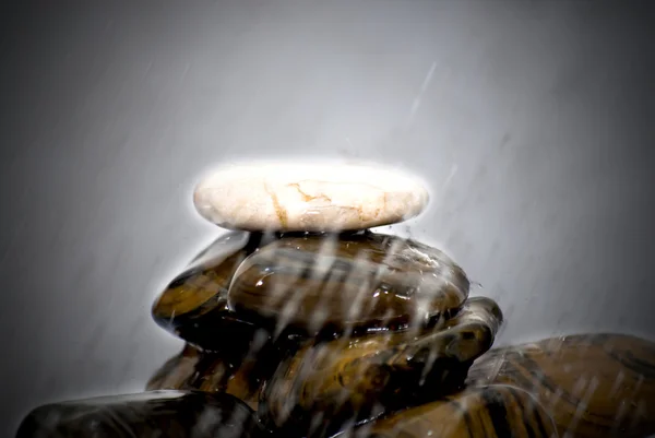 Drops of water falling on stones