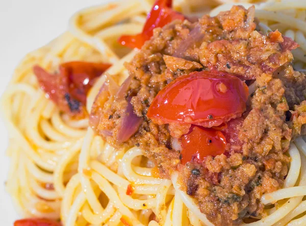 Colorful spaghetti with cherry tomatoes and peppers sauce