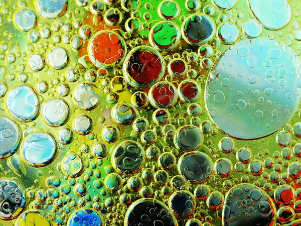 Olive oil bubbles in water close up