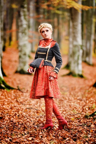 Beautiful elegant blonde woman in autumn forest