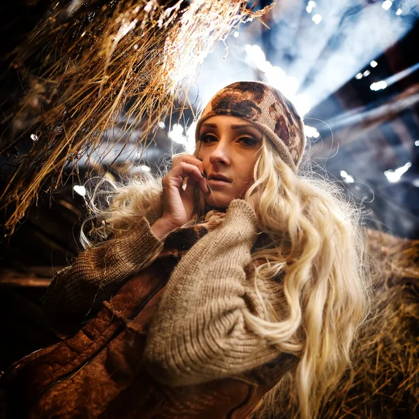 Beautiful woman relaxing in straw in autumn