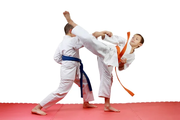 Sportsmen perform paired exercises karate