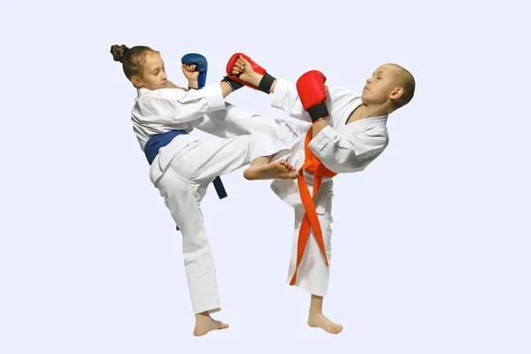 Sportsmen with overlays on hands are training hitting  mawashi geri
