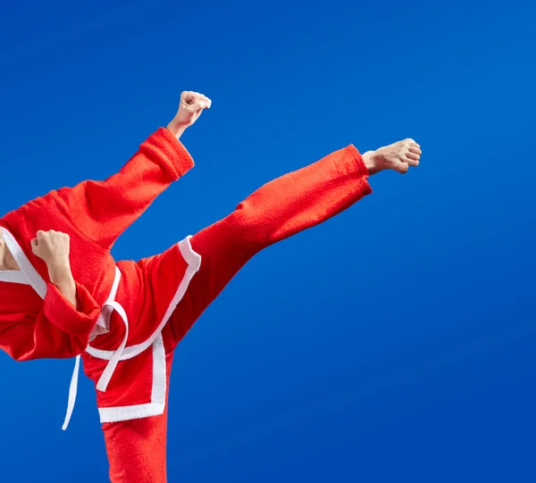 Karate blows and kicks in red Santa Claus clothes