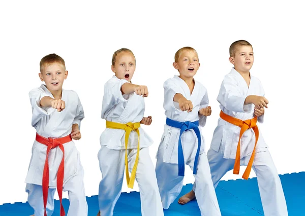 Cheerful children in karategi beats punch hand