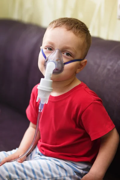 Small boy does therapeutic inhalation