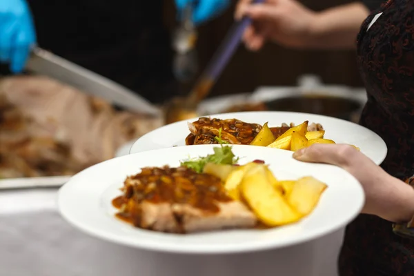 Restaurant workers prepare meals