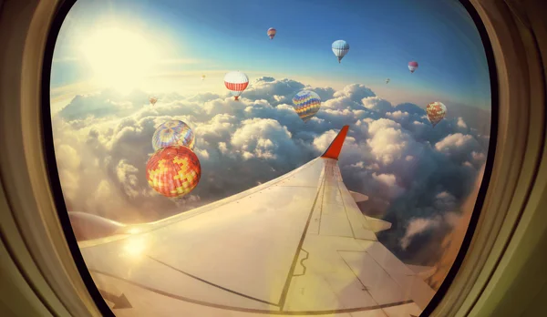 Clouds ,sky and Balloons as seen through window of an aircraft