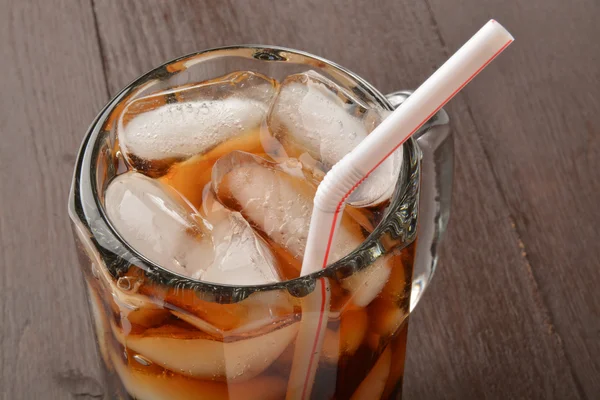 Cola in mug with straw
