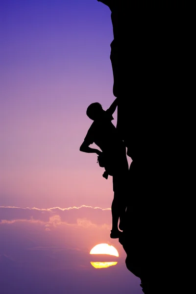 Man climbs at sunset
