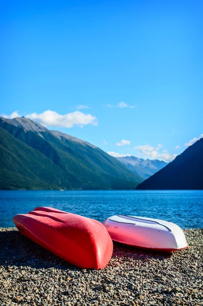 A recreation area with a couple colorful kayaks