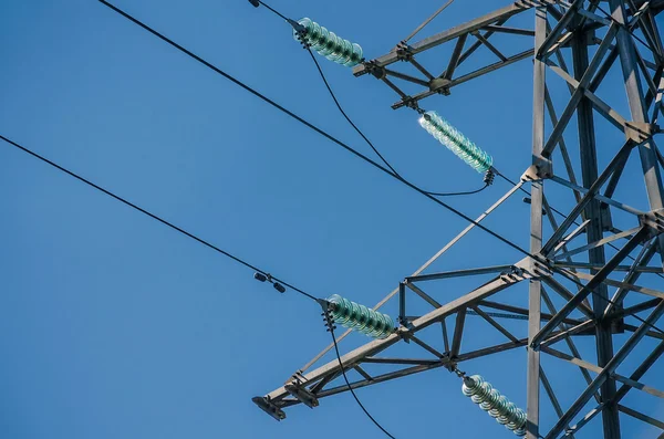 High-voltage tower on blue sky background.