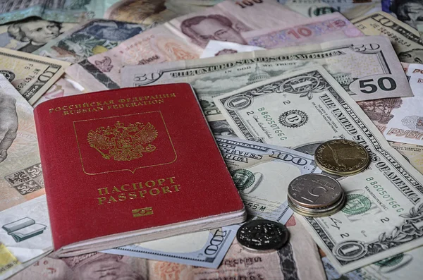 The Russian passport on a pile of  foreign currencies