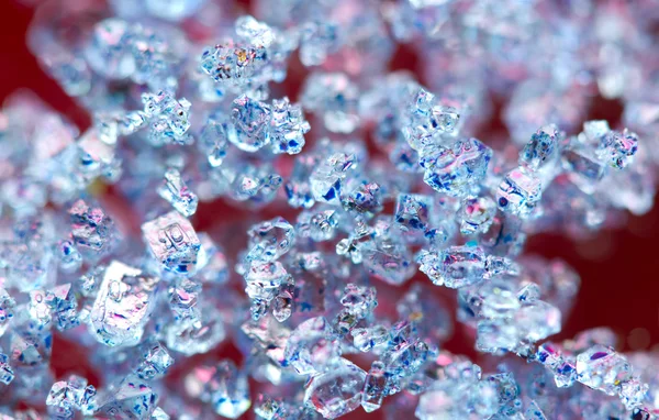 Blue crystals on a red background. Macro