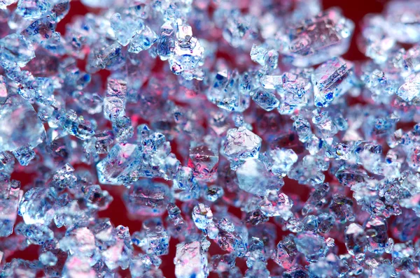 Blue crystals on a red background. Macro