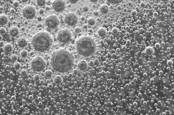 Macro Oxygen bubbles in water on black-and-white background