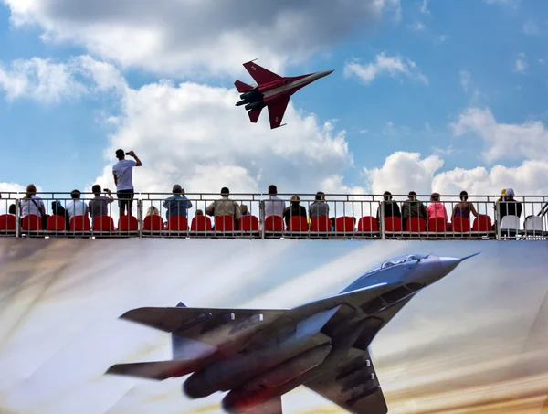 Russian fighter aircraft and spectators in the stands