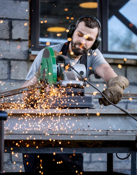 Industrial worker cutting metal
