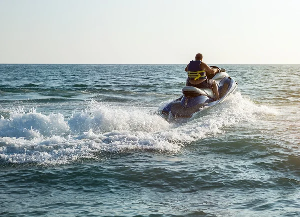 Silhouette of man on jetski at sea