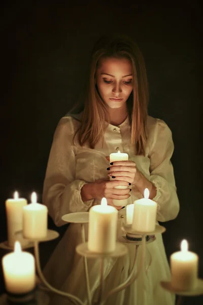 Young woman with candle in hand
