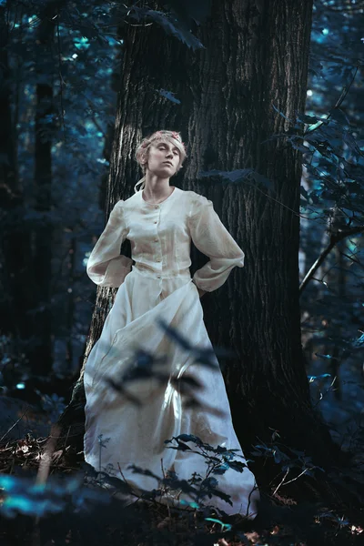 Elfin girl in a moonlight forest