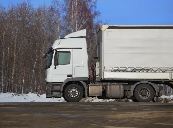 Truck goes on winter snow highway