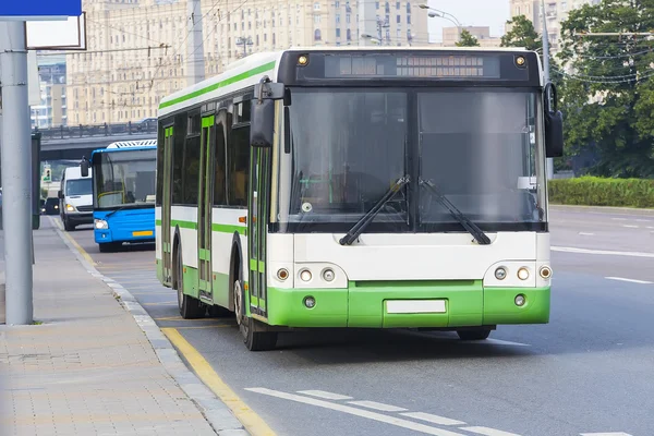 City bus goes along street