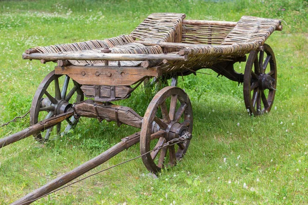 Ancient wooden cart on meadow