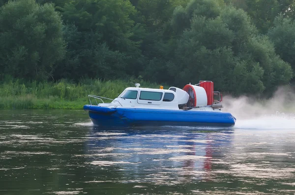 Boat with propeller moves down river