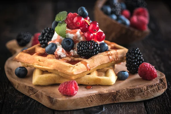 Traditional Belgian waffles with berry fruit and ice cream