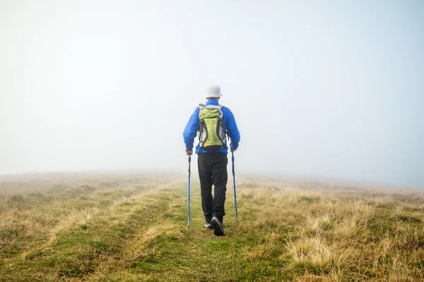 Man trekking in the fog