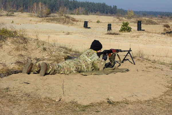 Soldier shoots from a shooting-iron, weapon