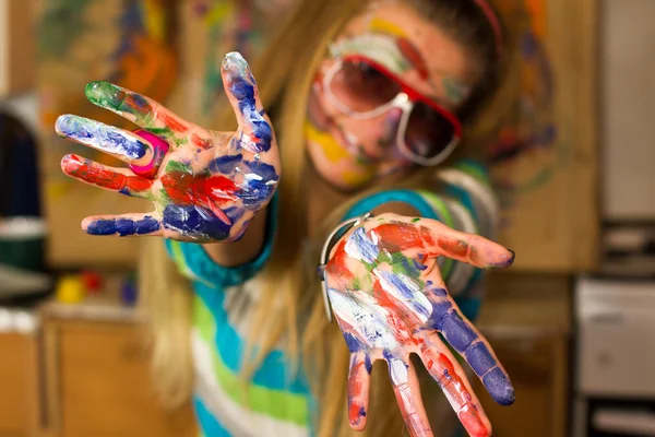 Young lady draw and  smile with color paints