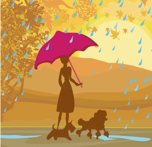 Girl walking with her dogs in autumn landscape.