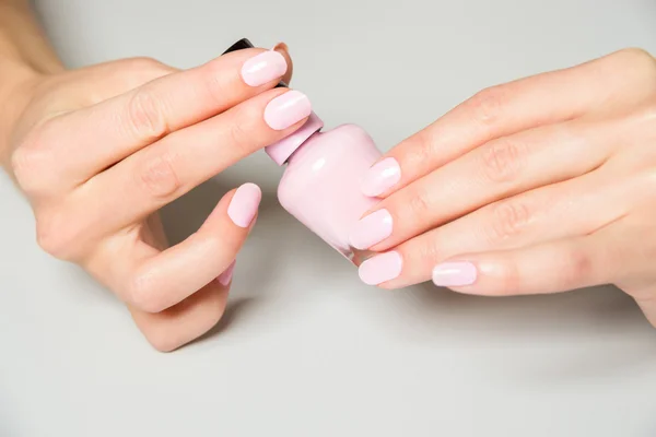 Pair of elegant hands with pink nail paint