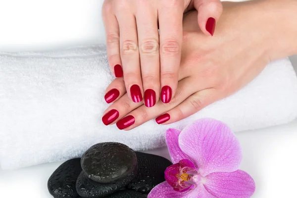 Spa theme of female hands with nail on towel