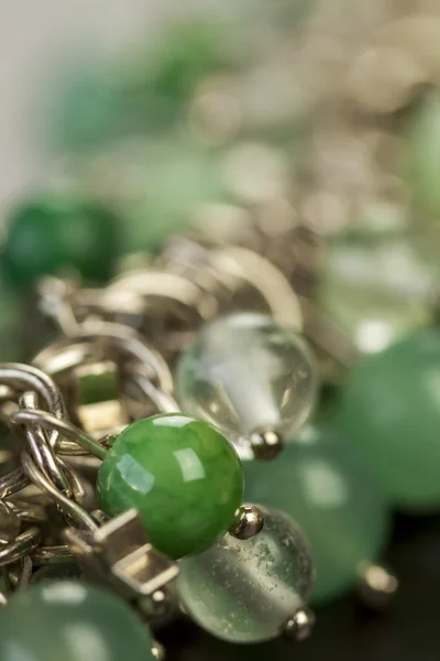 Green beads on silver jewelry