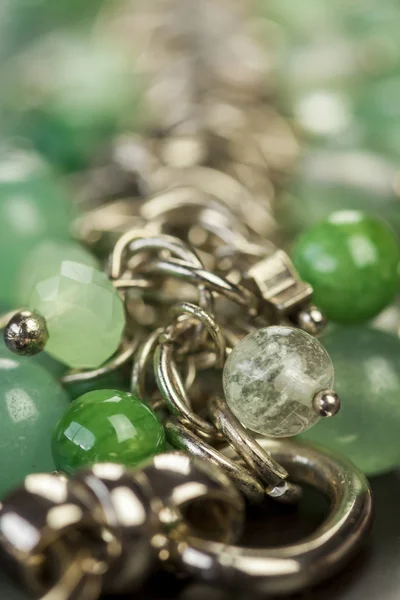 Green beads on silver jewelry