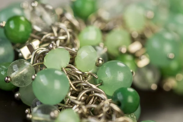 Green beads on silver jewelry